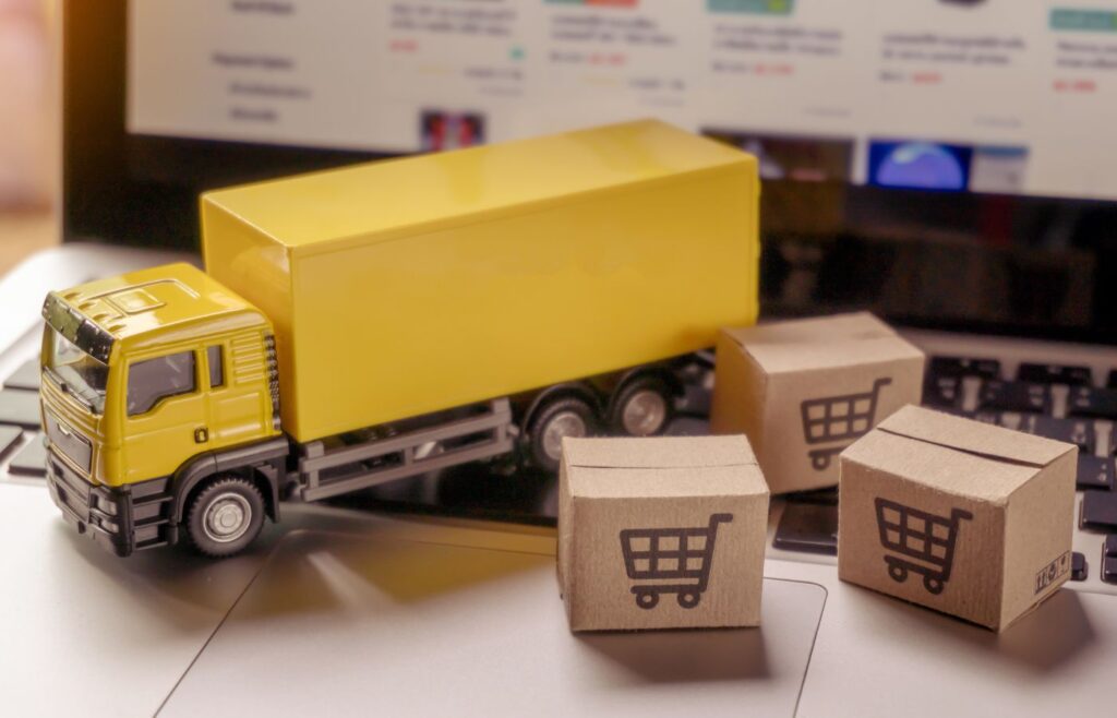 Shows a yellow truck model on a desk