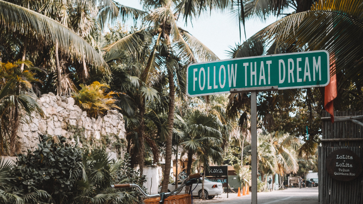 shows an image of a sign that says FOLLOW THAT DREAM - travel content writing