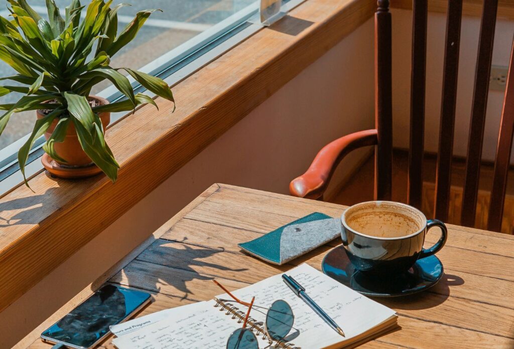shows a cup of coffee on a table - the ultimate guide to blog writing