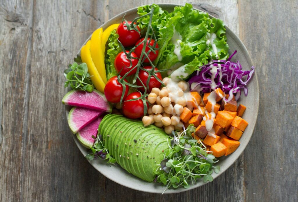 Shows a healthy salad with colourful food groups