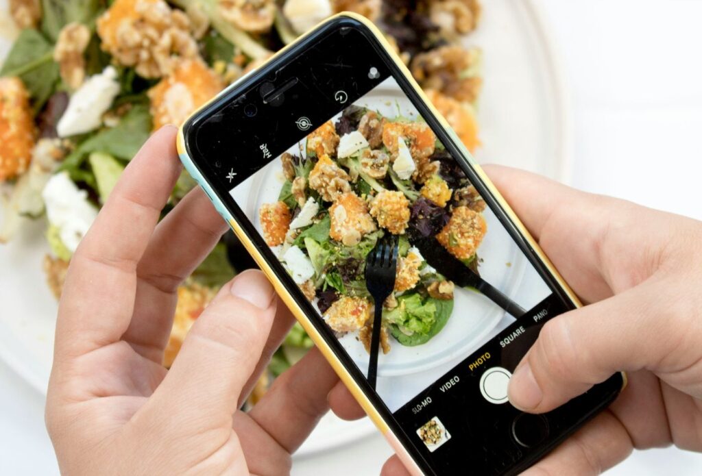 Food copywriting expert taking a photo of a menu dish