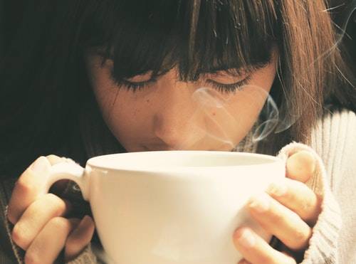 Food copywriting - Shows a woman smelling a cup of coffee