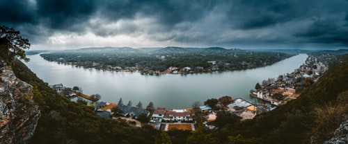 shows a landscape image of a lake and houses