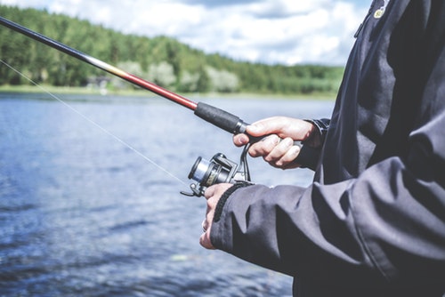 shows someone holding a fishing rod