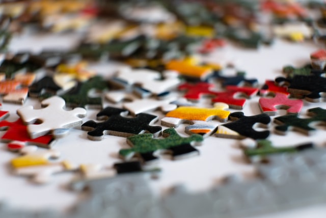 Shows a collection of coloured puzzle pieces