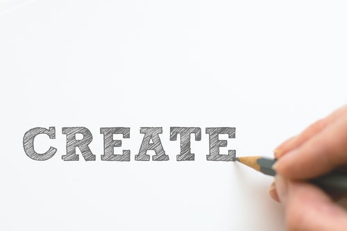 Shows a person drawing the word 'Create'
