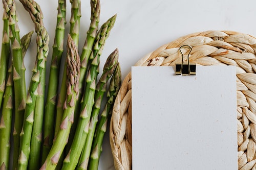 Food and drink content marketing - Shows a bunch of asparagus next to a notepad