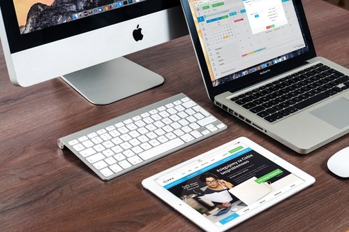 shows an image of a mac book on a wooden table