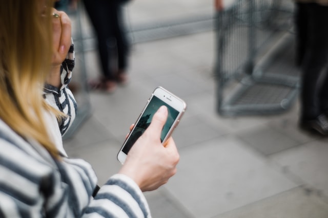 Shows a woman on her mobile phone