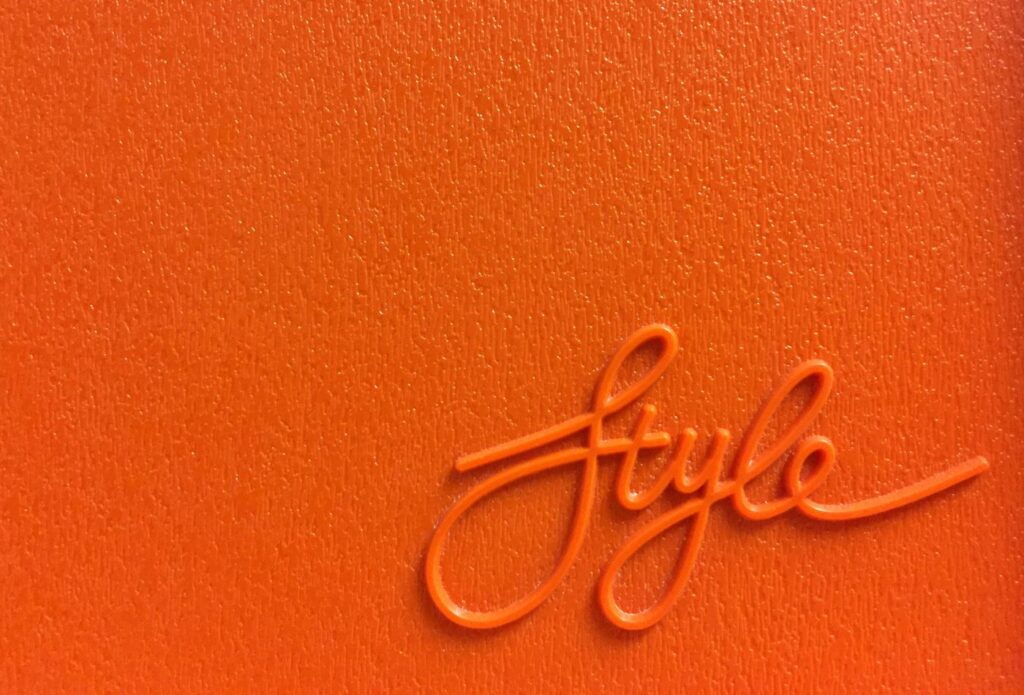 shows the word 'style' on a bright orange background