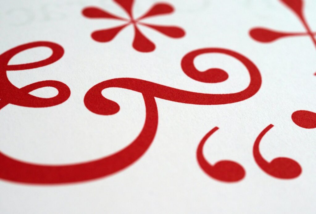 shows a red pattern on a white background - How to Create Brand Tone of Voice Guidelines