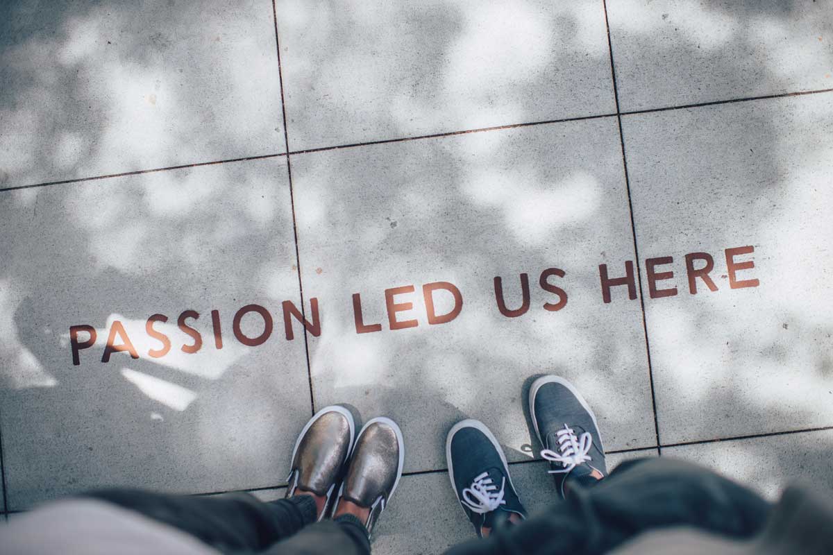 Shows a motivational quote on the pavement