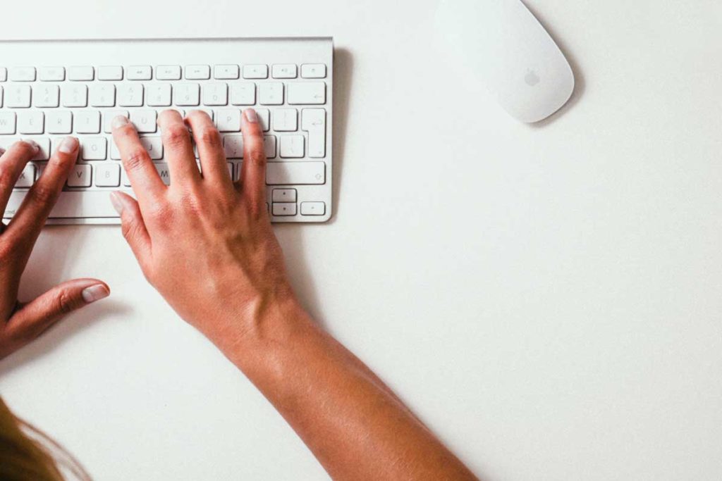 Shows a woman searching using a keyboard