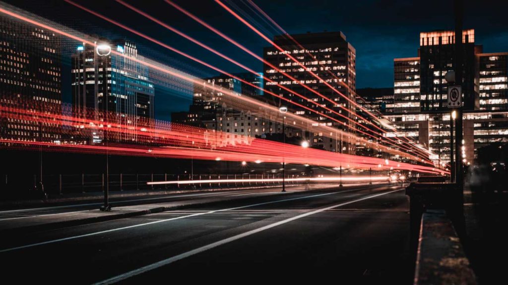 Shows a cityscape at night