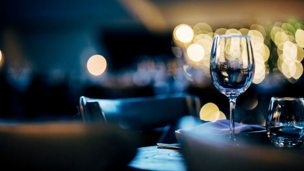 Wine glass in a moody, dimly lit room