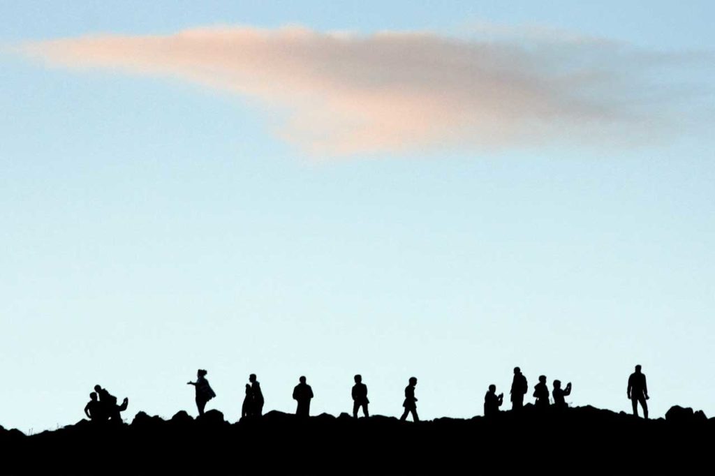 how to choose a copywriter - Shows silhouettes of people on a hill