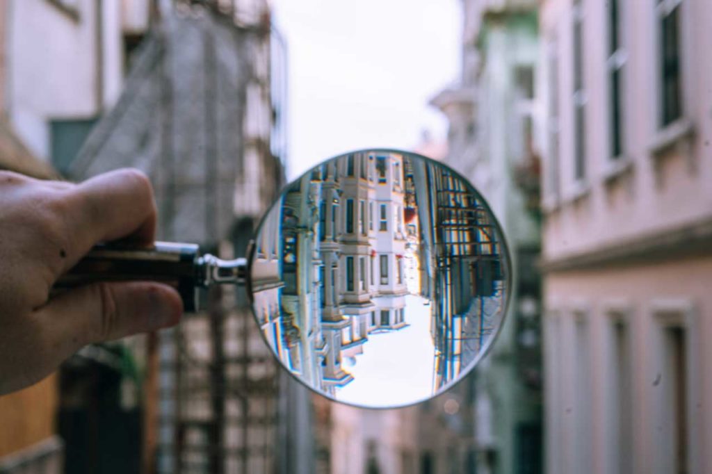 Duplicate content checkers - Shows a magnifying glass looking at a city