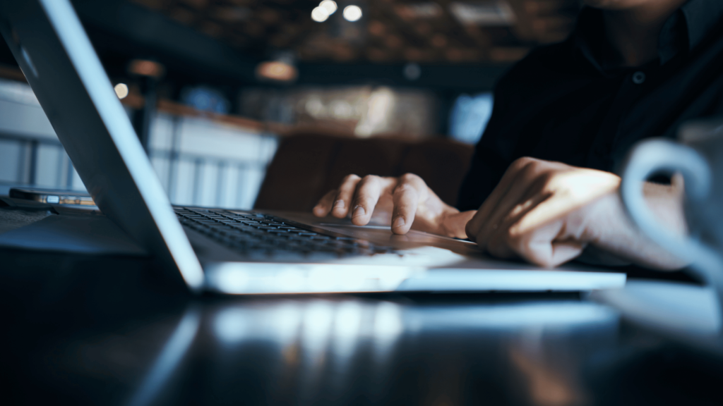 Essential copywriting skills - Shows a man typing on a laptop keyboard