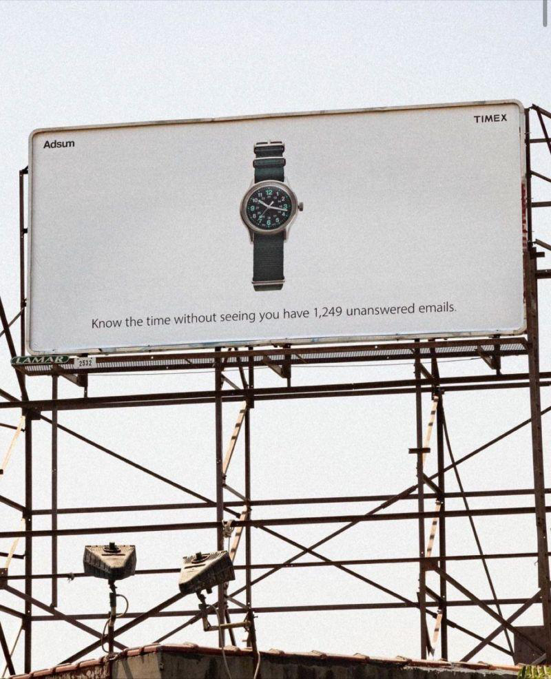 Shows a catchy watch advertisement on a billboard - Marketing campaign examples