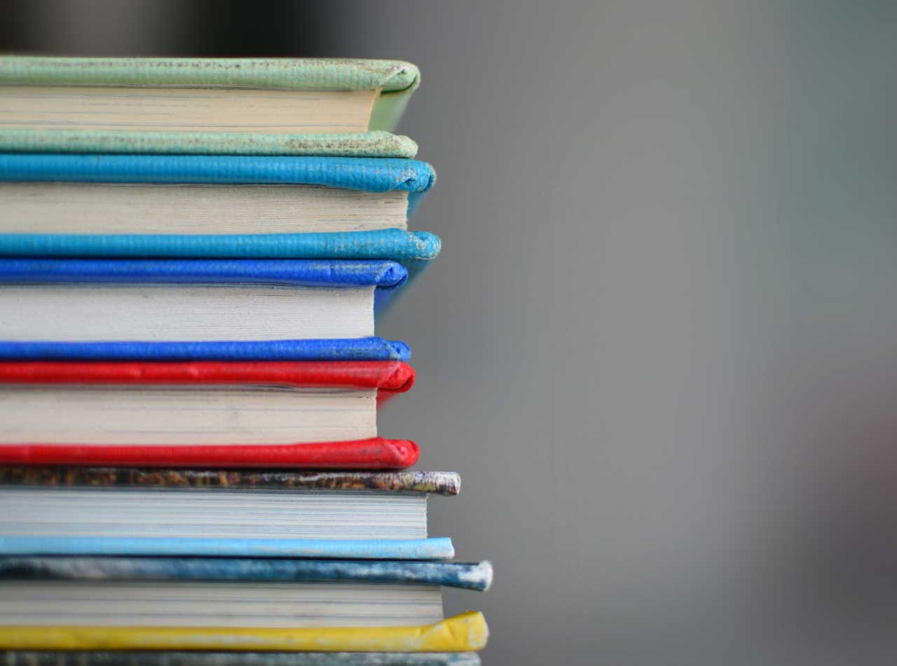 Educational content writer - Shows a stack of school books