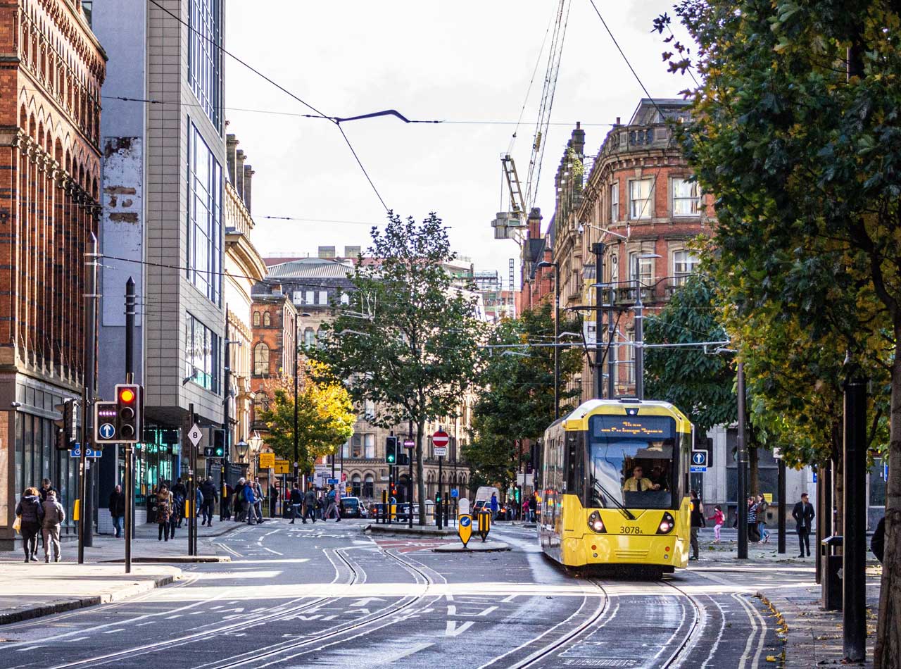 Shows a tram in Manchester City Centre