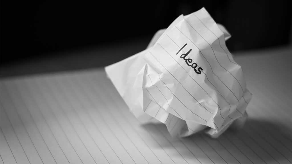 A scrunched up piece of paper with the word 'ideas'