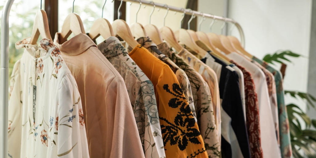 shows an image of clothes hanging on a metal rail - fashion blog ideas