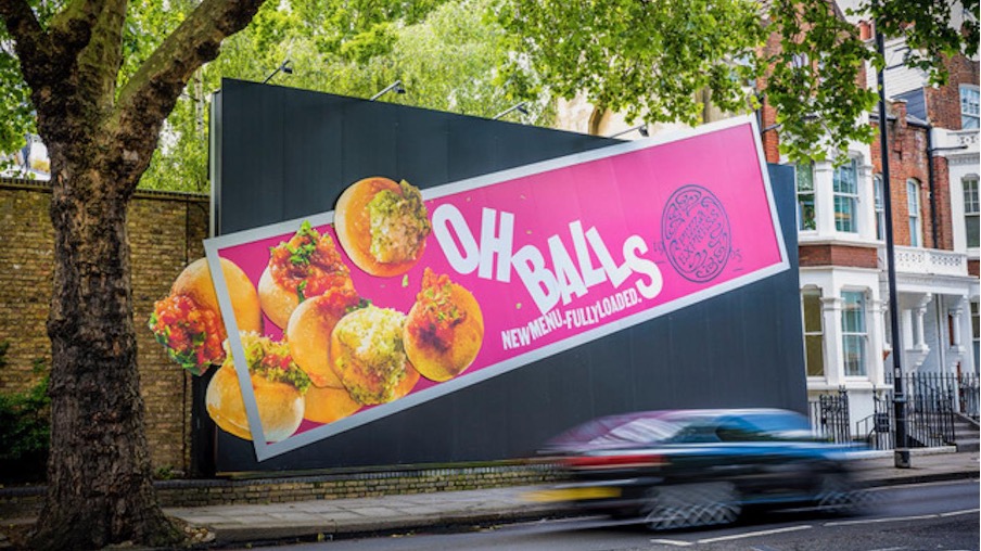 shows a billboard of pizza balls on a pink background - food description examples