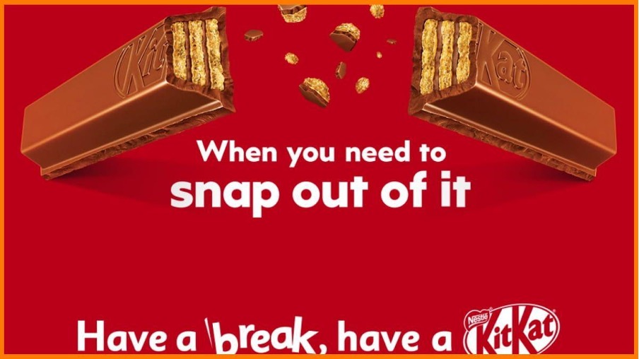 shows a kit kat broken in half on a red background