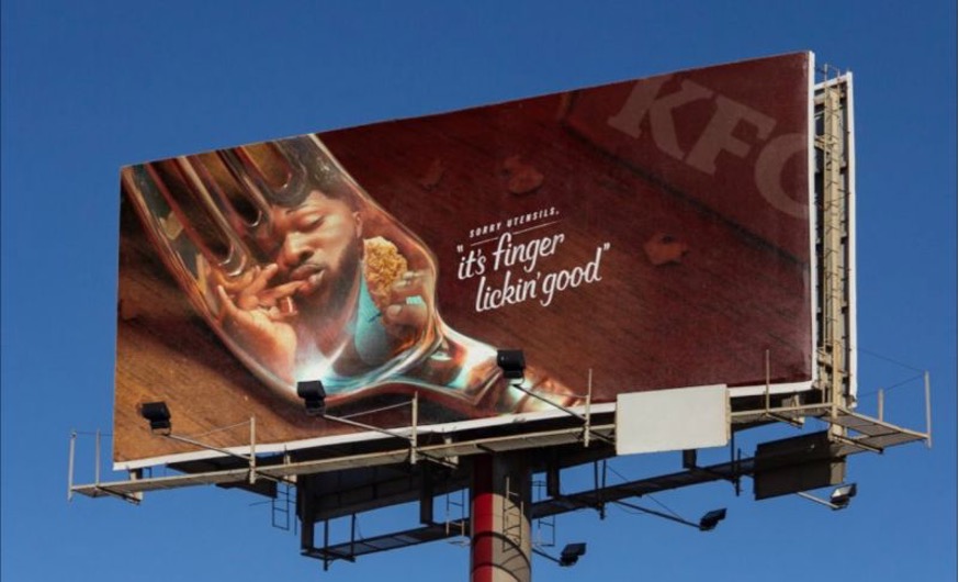 shows a billboard of a fork and a fan eating chicken