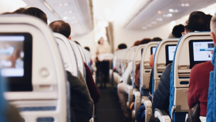 shows an image of people sitting on a plane