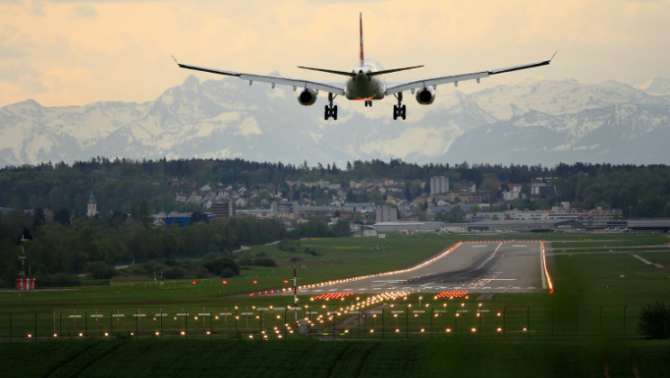 shows an image of a plane on top of the run way - travel content writing