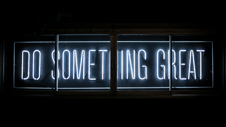 Image says the words DO SOMETHING GREAT in neon - content marketing guide 