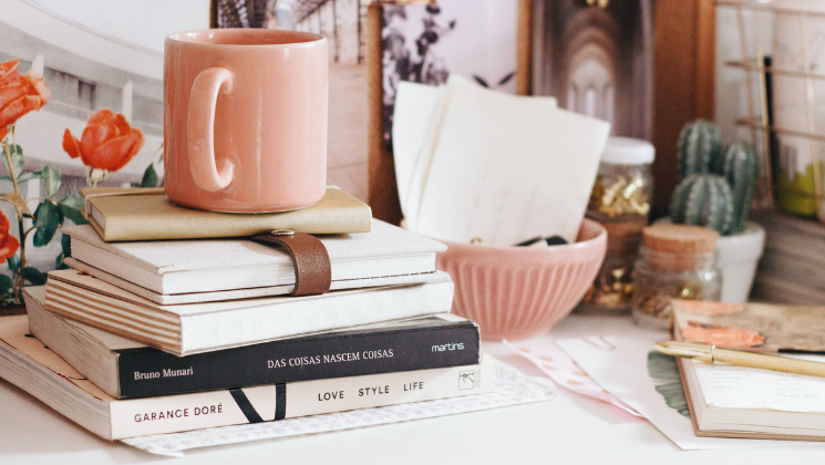 shows an image of a pink mug on top of books - content marketing guide