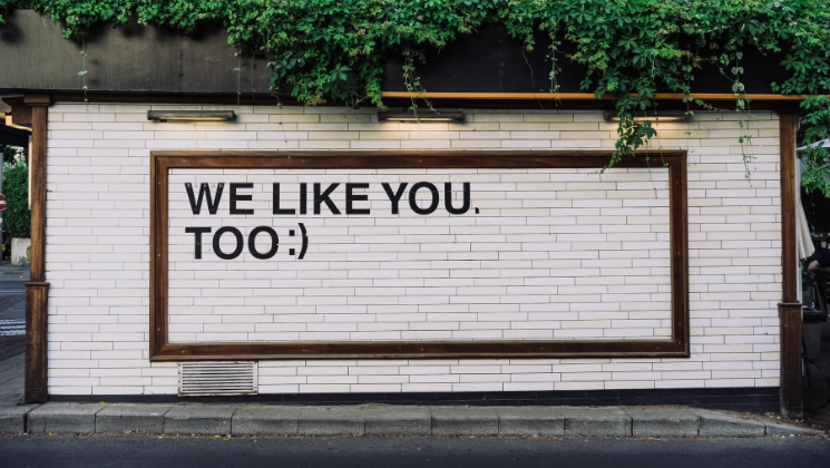 shows an billboard that says WE LIKE YOU TOO - content marketing guide