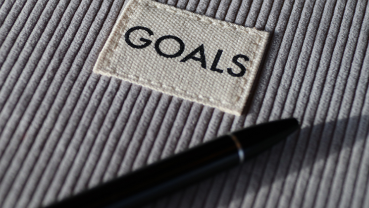 shows an image of the word 'GOALS' next to a pen - Content marketing guide