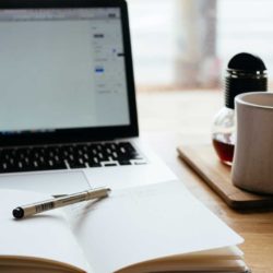 Ultimate guide to content marketing - Shows a laptop and notepad