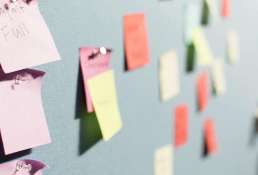 shows colourful post-it notes on a board