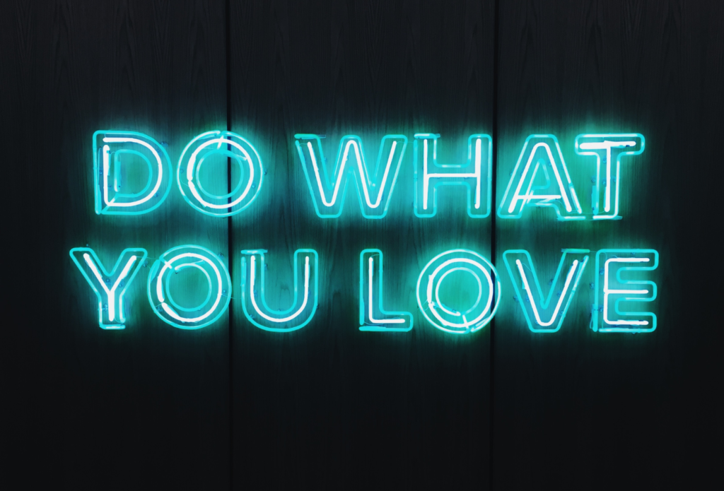 shows a neon blue sign saying 'DO WHAT YOU LOVE'
