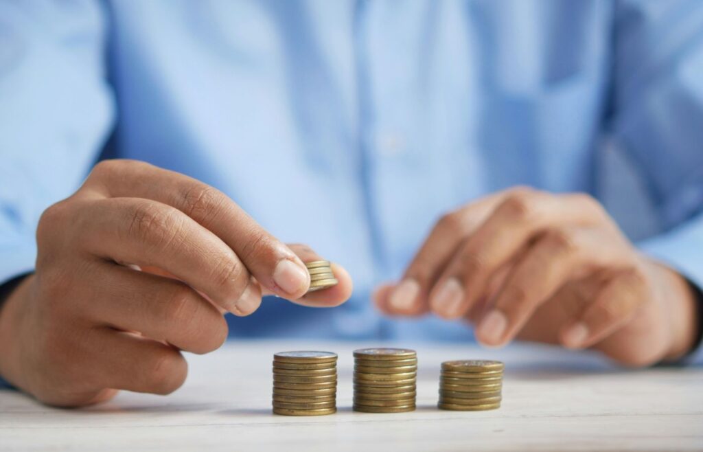 shows a man stacking coins - insurance content marketing guide
