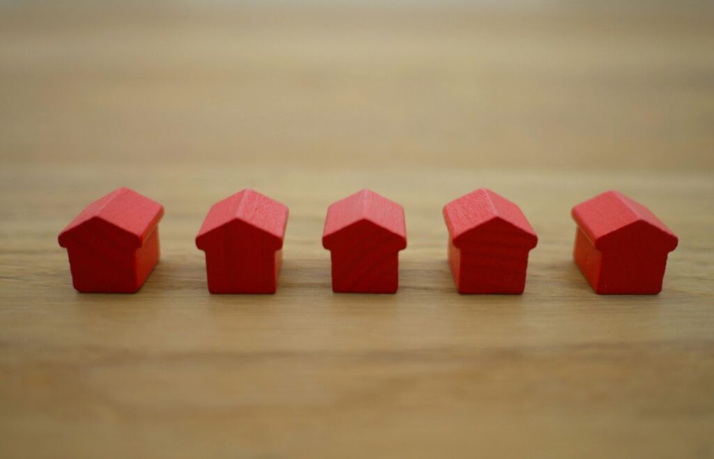 Insurance content marketing strategy guide - Shows a row of red Monopoly houses