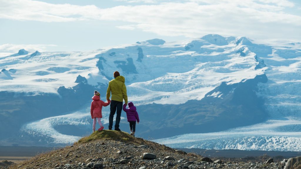 Shows a family looking out at the mountains - Travel blog ideas
