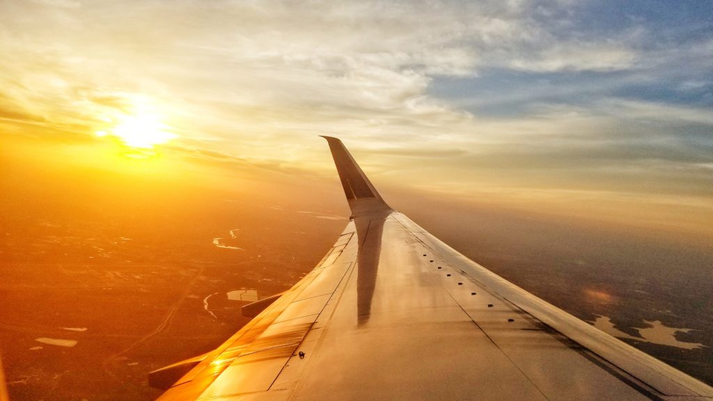 Scenic view of an aeroplane wing at sunset - Travel blog topic ideas