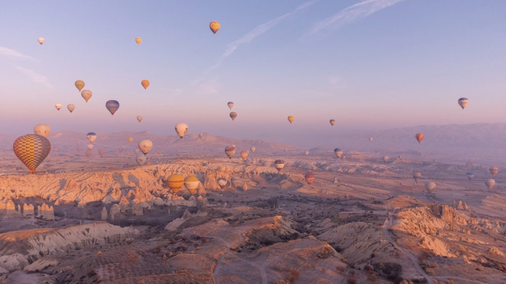 Hot air balloons rising at sunset in Turkey - Travel blog post ideas