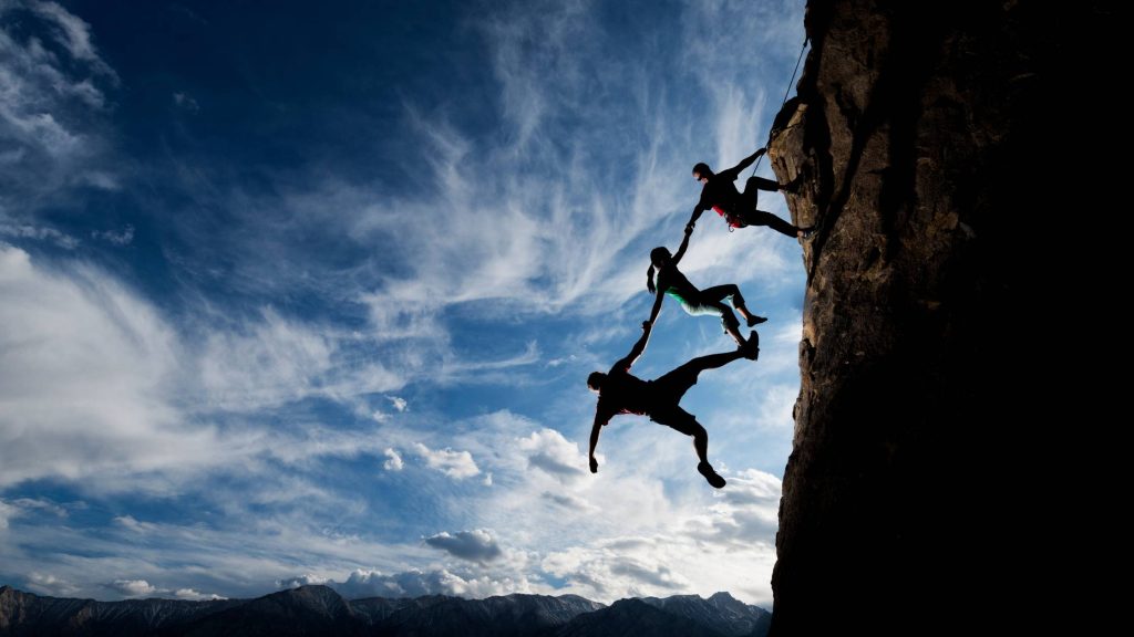 shows people holding on to eachother going down a rock - digital marketing in the insurance industry