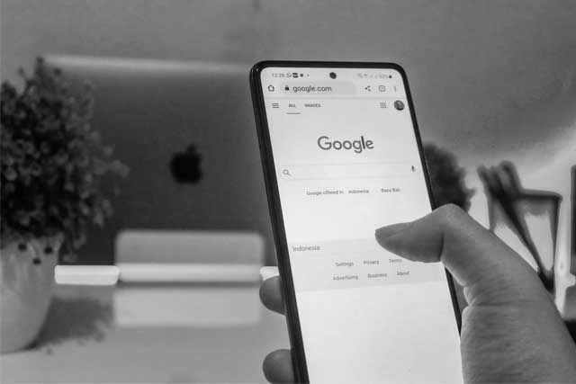 Google Ads agency UK - Shows a person using Google Search on their phone