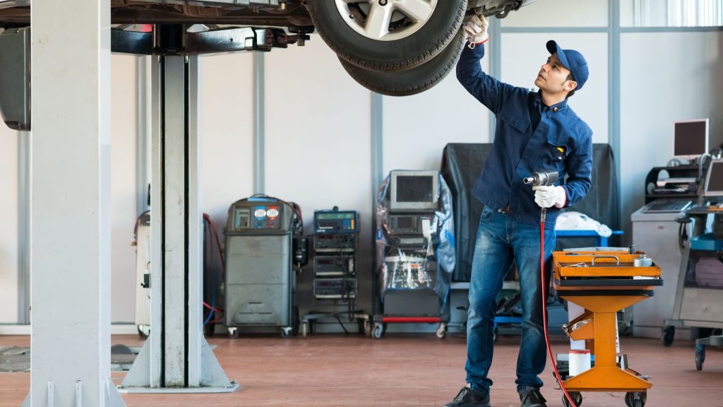 shows a mechanic fixing a car