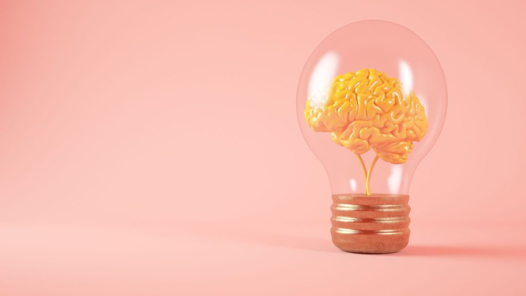 Shows a lightbulb on a pink background - A 2025 Digital Marketing Audit Guide