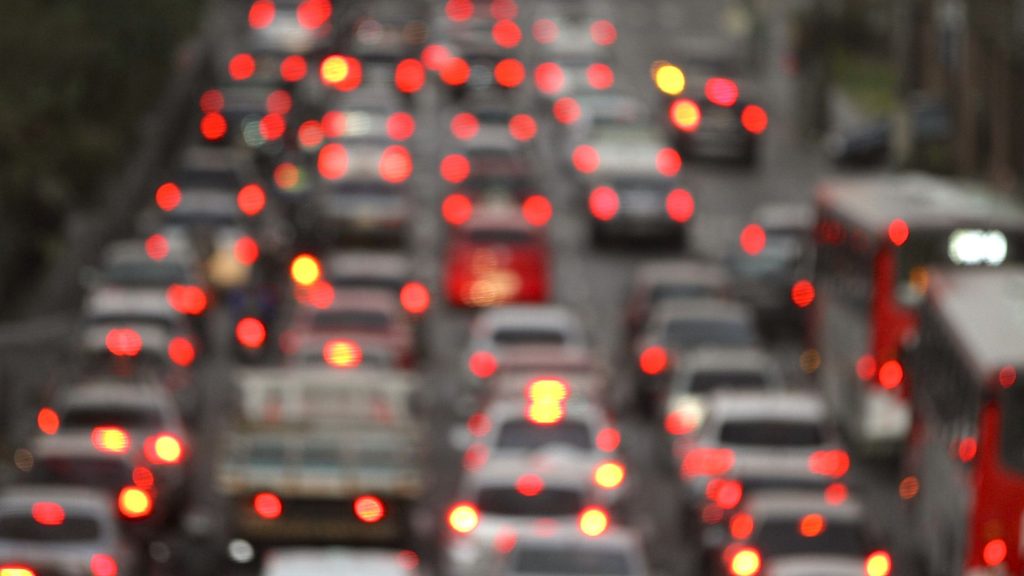 shows a blurred image of cars stuck in traffic