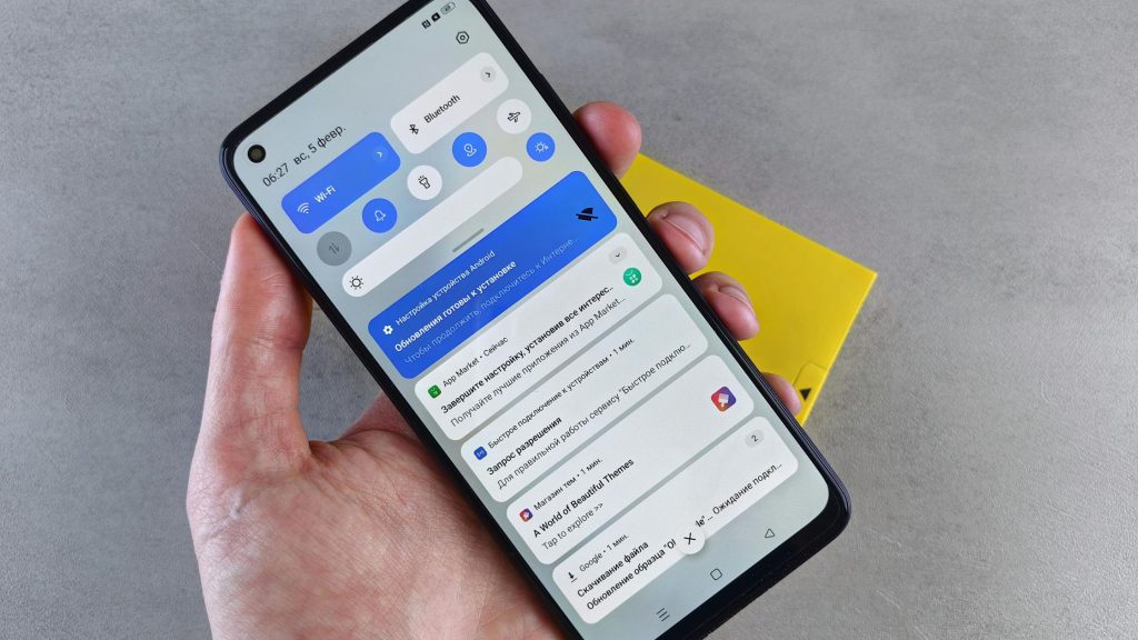 Shows someone holding a mobile phone 
